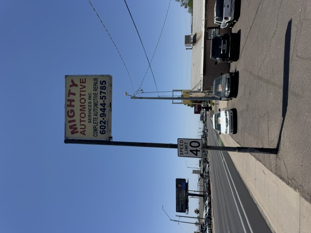 The Mighty Automotive roadside sign on Cave Creek Rd advertising complete automotive repair